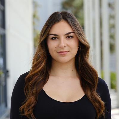 a woman standing straight towards camera for headshot